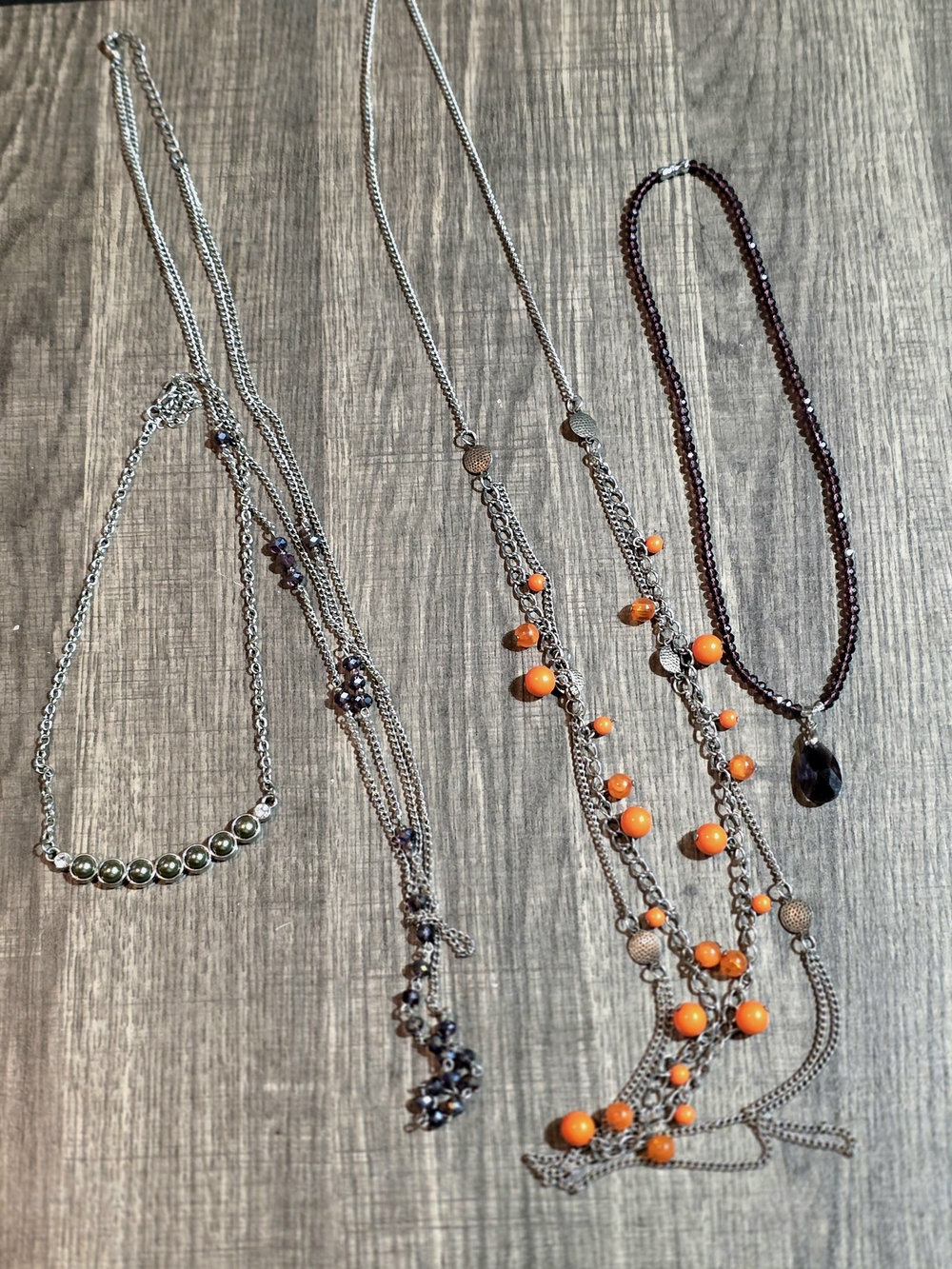 4 Pack Of Costume Jewelry. 2 Long, 1 Purple And 1 Silver, Green And White